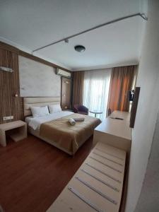 a bedroom with a bed and a desk in it at Moonstar Hotel in Kusadası +12 photos