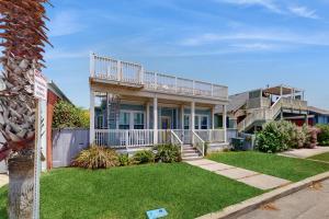 a house with a balcony and a yard at The Salty Whale in Galveston