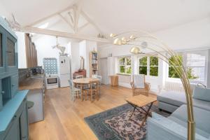 a kitchen and living room with a couch and a table at Le Nid des Rossignols in Angers