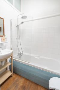 a bathroom with a shower and a sink and a tub at Le Nid des Rossignols in Angers