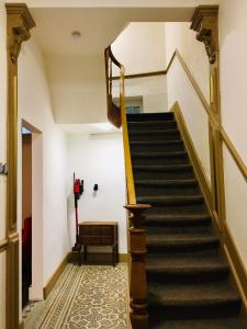 a staircase in a building with a stair case at Chambre 1 Namur à vélo in Namur