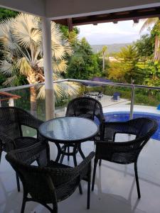 a patio with a table and chairs and a pool at Casa Pinilla- Perfecta para Paseos in Ricaurte