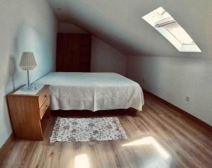 a bedroom with a bed and a table with a lamp at Pure Mountain - Serra da Estrela in Erada