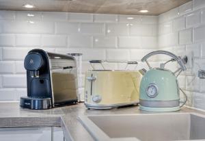 a toaster and toaster sitting on a kitchen counter at Bella Notte - 10 min from DisneyLand, Free Parking, Self Check-in, 7 pers in Montévrain
