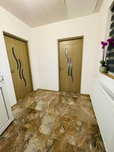 a room with two doors and a marble floor at Casa Claudia si Cristi in Tuzla +13 photos