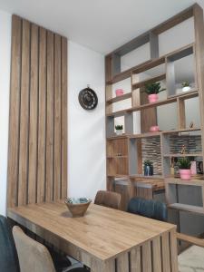 a dining room with a wooden table and chairs at Cera exclusive apartment in Soko Banja