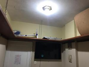 a kitchen with a ceiling with a light on it at Quarto Privativo - Pitangueiras - 50mts da Praia in Guarujá +3 photos