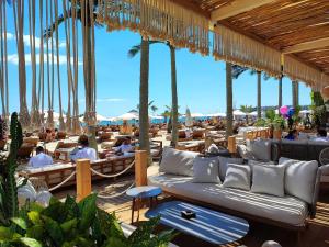 Un restaurante con sofás y mesas en la playa. en Sunny Beach Cozy Apartment With a Pool, en Sunny Beach