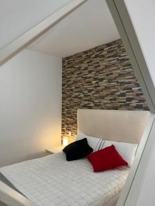 a bedroom with a bed with two pillows on it at Silver House 96 ideal parejas in Arrecife