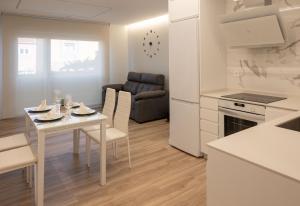 a kitchen and living room with a table and a couch at Rest Pedrouzo in O Pedrouzo