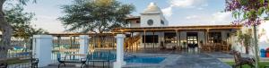 a building with a clock tower and a pool at Bodega el Huarango in Ica +61 photos
