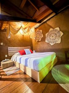 a bedroom with a bed in a room with decorations at Posada El Palomar in Pátzcuaro