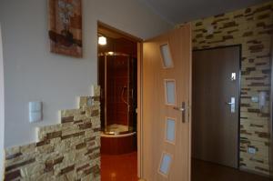 a bathroom with a walk in shower next to a door at Apartament Classic in Szczecin