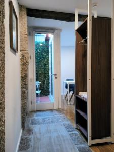 a hallway with a door leading to a patio at DOMI Suites & Studios in Guimarães +22 photos