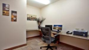an office with a desk with a computer and a chair at Candlewood Suites New Iberia by IHG in New Iberia +40 photos