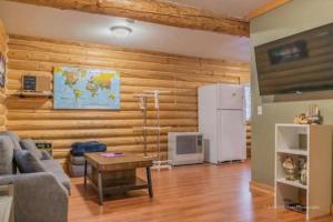 a living room with a couch and a refrigerator at Cabin in the woods Fairbanks, Alaska, United States in Fairbanks