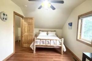 a bedroom with a bed and a ceiling fan at Cabin in the woods Fairbanks, Alaska, United States in Fairbanks