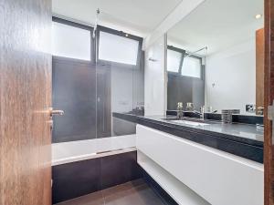a bathroom with two sinks and a large mirror at Villa Ribeiro Real 12 A in Câmara de Lobos +37 photos