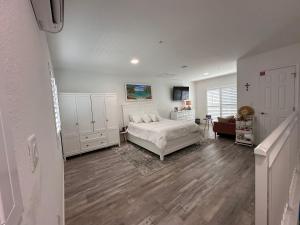 a white bedroom with a bed and a living room at Paradise awaits you!!!! in Marathon +16 photos