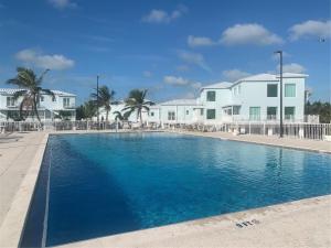 a swimming pool in front of some white houses at Paradise awaits you!!!! in Marathon