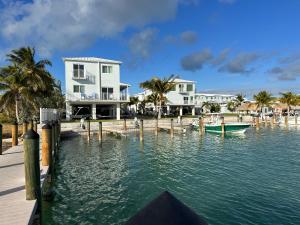 a boat in the water in front of a house at Paradise awaits you!!!! in Marathon