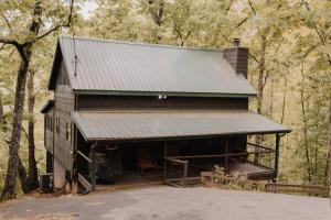 a cabin in the woods with a metal roof at Misty Mountain Sunrise in Sevierville