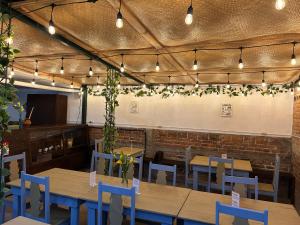 a restaurant with wooden tables and blue chairs at Hotel Casa Blanca Antigua Guatemala in Antigua Guatemala
