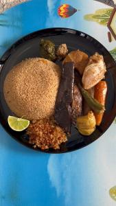 a plate of food with meat and vegetables on a table at ASimmo in Dakar +29 photos