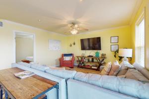 a living room with a couch and a tv at Fortuna Sea Brisas Condominiums #4 in Corpus Christi