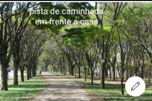 a tree lined path with a sign that reads pasta de campilli era french at Studio 01 Quarto 3 in São José dos Campos +4 photos