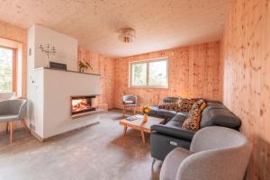 a living room with a couch and a fireplace at Villa Zirbenherz in Gotha