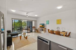 a kitchen and living room with a table and a dining room at Yanti at Nightcliff - Foreshore - Pool - Shops & Cafe in Nightcliff