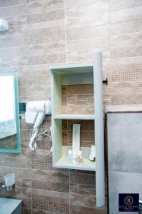 a bathroom with a shelf with a hair dryer at Royal Mgwasi Hotel in Mbeya +76 photos