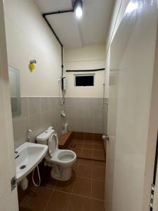 a bathroom with a toilet and a sink at The Cove Homestay Sandakan - seaview in Sandakan +14 photos