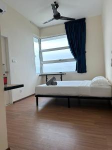 a bedroom with a bed and a large window at The Cove Homestay Sandakan - seaview in Sandakan