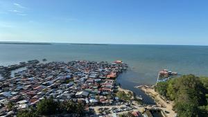 an overhead view of a large crowd of houses in the water at The Cove Homestay Sandakan - seaview in Sandakan