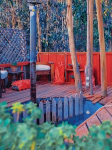 a wooden deck with a bench and a table at Domos la Resiliencia in Casablanca