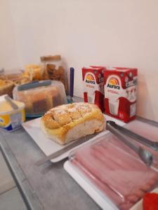 a counter top with a sandwich and a box of food at Hotel Perola Ltda in Cuiabá +52 photos