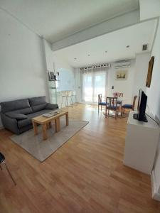 a living room with a couch and a table at La terraza del pilar in Zaragoza