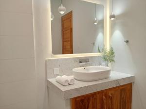 a bathroom with a sink and a mirror at ELEVATE - Uluwatu, Bali in Uluwatu