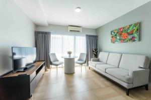 una sala de estar con un sofá y una mesa en Chiva Bangkok Hotel - SHA Plus, en Bangkok
