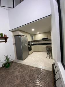 a large kitchen with a stove and a refrigerator at Espectacular casa en Manizales in Manizales