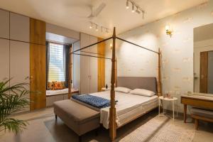 a bedroom with a canopy bed and a bathroom at Saur Homestay in Jaipur +35 photos