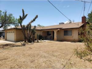 a house with a palm tree in the yard at Quaint Vintage Ranch Style 4BedRoom 2Bath Sleeps 10 in Lancaster