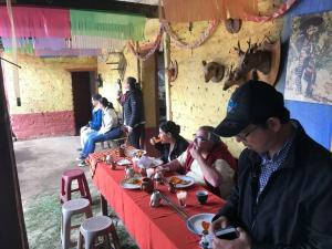 a group of people sitting at a table with food at Casa Diego Ignacio in Chichicastenango