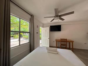 a bedroom with a bed and a ceiling fan at La Diosa Kali Beach Front Hotel in Holbox Island