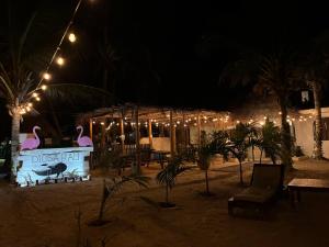 a restaurant at night with lights and palm trees at La Diosa Kali Beach Front Hotel in Holbox Island