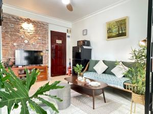 a living room with a couch and a table at Amazing View, Natural View, 3' To Hoan Kiem Lake, Free Wifi, Netflix, 2 Beds, 1 Toilet-2 Showers in Hanoi