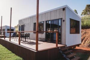 a modular house with a deck with a table at High Valley Dawn Permaculture Farm in Yeppoon