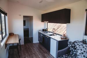 a kitchen with a sink and a counter top at High Valley Dawn Permaculture Farm in Yeppoon